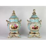 A pair of large 19th Century floral decorated two handled Urns with lids, possibly Rockingham,