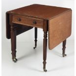 An attractive 19th Century Pembroke Table, with frieze drawer on reeded legs and brass castors.
