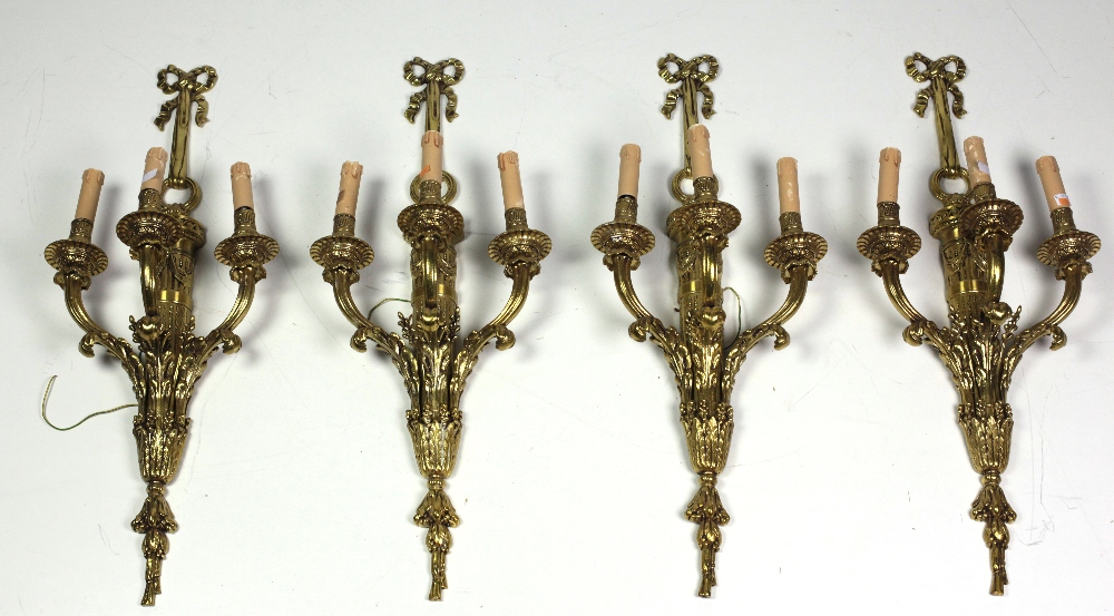 A suite of four Louis XVI style three branch Wall Lights, decorated in the Adams taste.