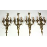 A suite of four Louis XVI style three branch Wall Lights, decorated in the Adams taste.