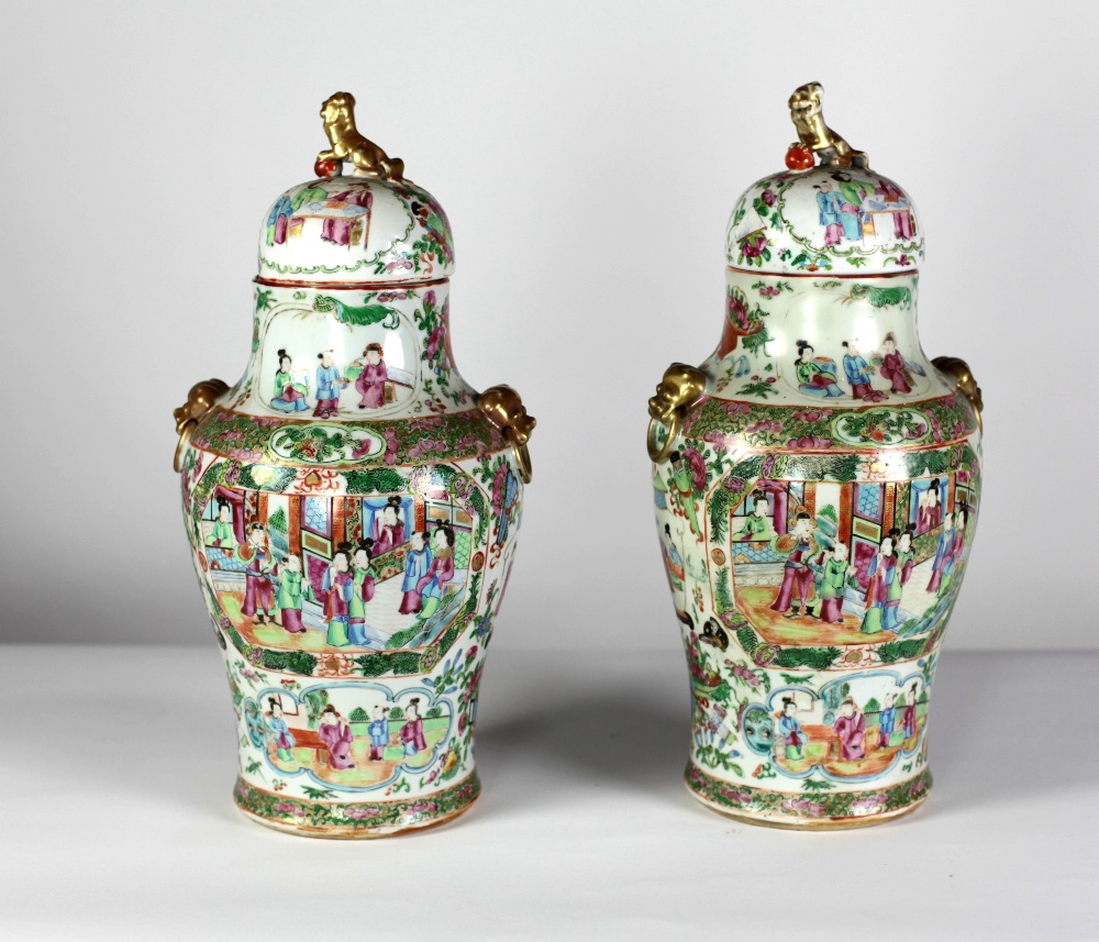 A pair of 19th Century Cantonese Vases and Covers, the lids mounted with Dogs of Foo,