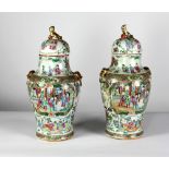 A pair of 19th Century Cantonese Vases and Covers, the lids mounted with Dogs of Foo,
