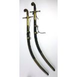 An early 19th Century Indian Sabre, in an engraved brass and animal skin scabbard,