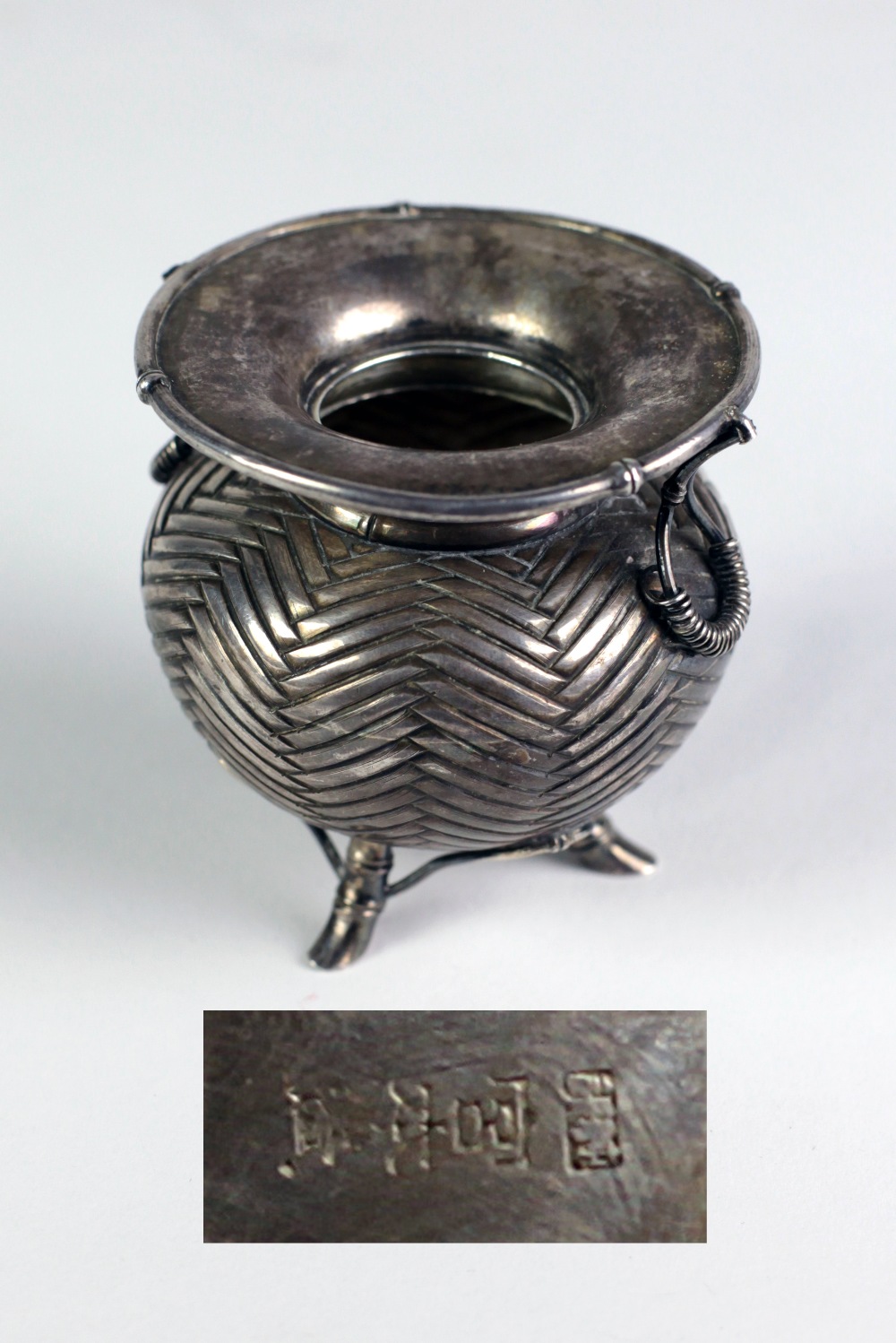 A Chinese silver Pot, with two handles on a simulated basket weave body on three bamboo legs, 7.