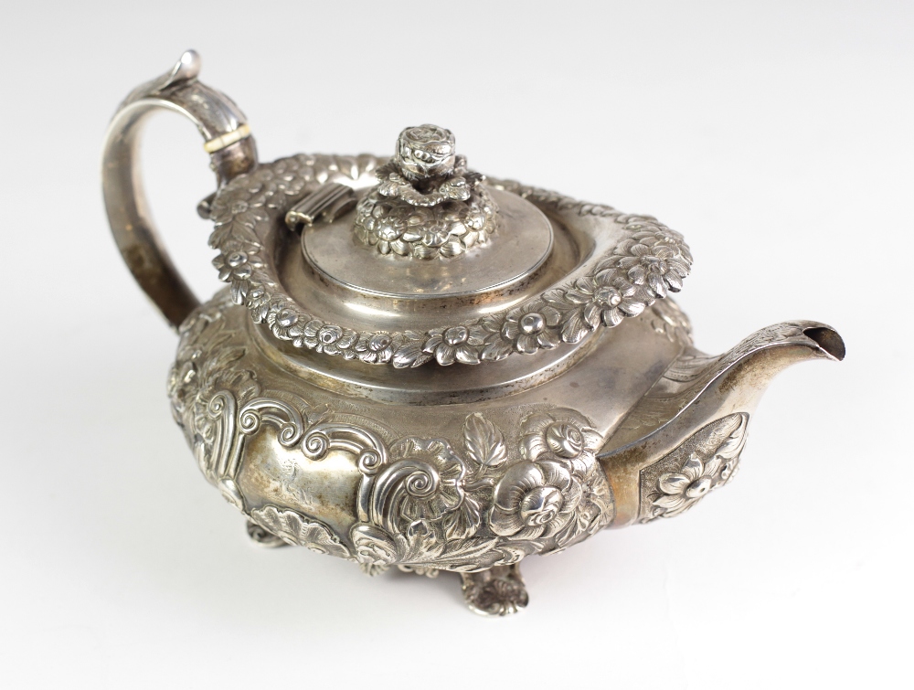 An attractive and heavy Georgian period silver Teapot, of floral repoussé design by William Nolan,