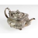 An attractive and heavy Georgian period silver Teapot, of floral repoussé design by William Nolan,