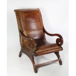 An unusual and large oak X framed Easy Armchair, with scroll arms covered in hide.