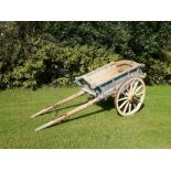 A horse drawn Cart, with spoke and iron wheels.