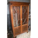 A mahogany Chippendale style Wardrobe, with two glazed and panel doors, on bracket feet.