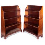 An attractive pair of Georgian style mahogany waterfall four shelf Bookcases, on bracket feet,