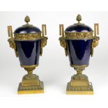 A pair of attractive 19th Century blue ground porcelain and ormolu mounted Urns & Covers,