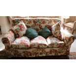 A large three seater Couch, covered in cream ground floral loose tapestry,