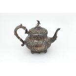 A good heavy early Victorian Irish silver Teapot, the profusely embossed and chased body,