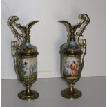 An attractive pair of 19th Century hand painted Continental porcelain and brass mounted Ewers,