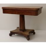 A heavy Victorian mahogany fold-over Tea Table, on octagonal pillar support and quatrefoil base.