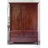 A 19th Century figured mahogany two door Wardrobe, on a base with two short and one long drawer,