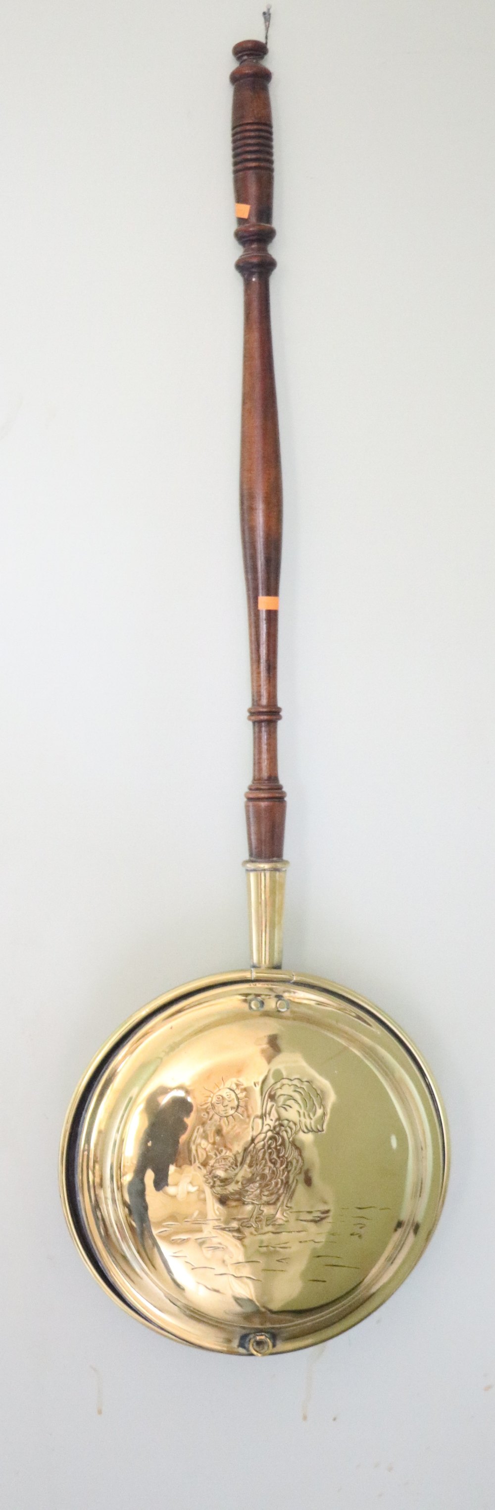 An antique engraved brass Bed Warmer, with turned wooden handle.
