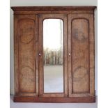 A large Victorian figured walnut three door Wardrobe, with centre mirror door.