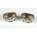 A pair of 19th Century French silver Roman bath shaped and glass lined Salts.