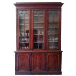 An early 19th Century figured mahogany Bookcase, the super structure with a moulded cornice,