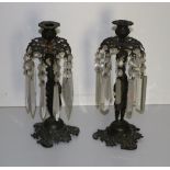 A pair of early 19th Century bronzed Figural Candlestick Lustres, with cutglass drops.