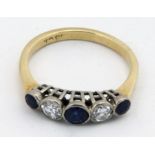 An attractive five stone diamond and sapphire Ring, set in 18ct gold, decorated with .