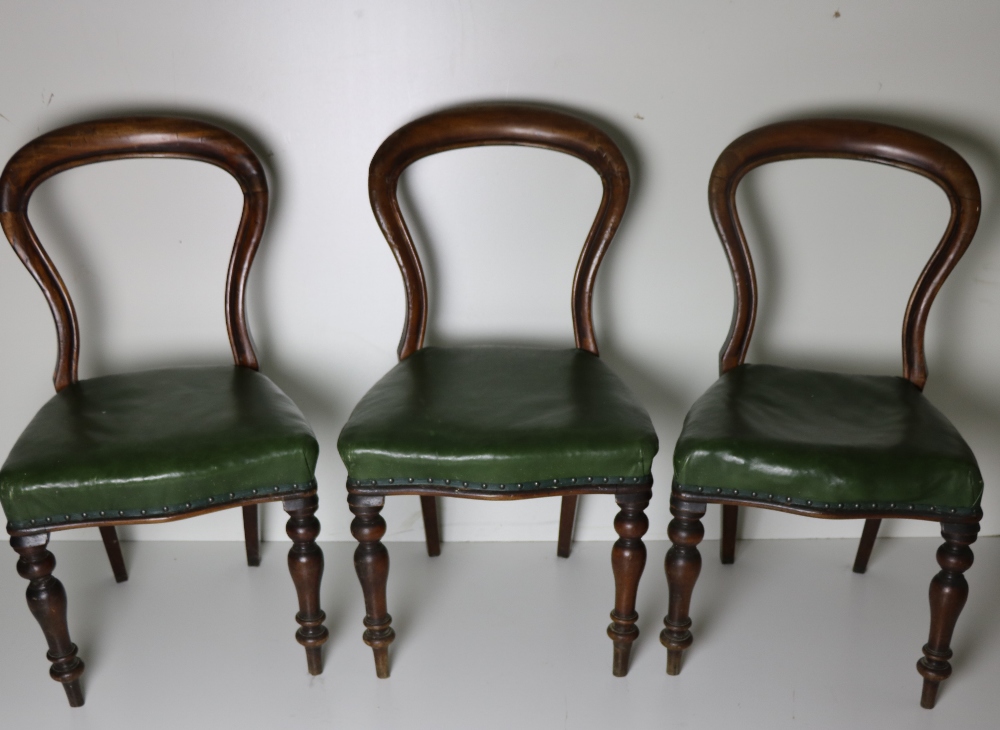 A set of 3 Victorian spoon back Chairs, with green leather seats.