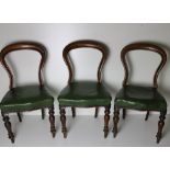A set of 3 Victorian spoon back Chairs, with green leather seats.