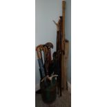 A collection of varied Walking Sticks, whips, folding rests, fishing reels and rods, foxes tails,