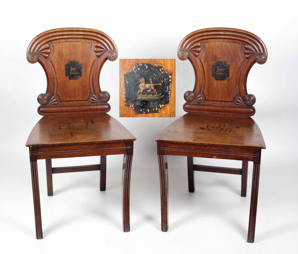 A pair of William IV Irish mahogany and crested Hall Chairs, possibly the Carew Family,