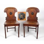 A pair of William IV Irish mahogany and crested Hall Chairs, possibly the Carew Family,