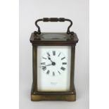 A small brass cased Carriage Clock, the white enamel dial with Roman numerals, and signed Rosenthal,