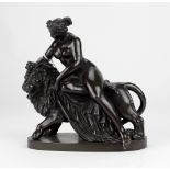 A 19th Century bronze Figure of Nude Lady, resting on a lion, approx.
