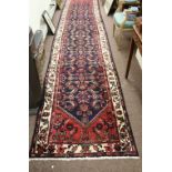 A heavy woolen Middle Eastern style claret ground Runner,