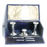 A Victorian silver Stationery Set, in original box, comprising inkwell, two candlesticks and pen.