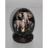 An unusual painted Ostrich Egg, depicting African wildlife and a map of the Continent,