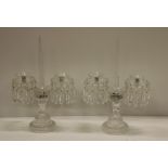 A pair of Waterford glass two branch Candlesticks/Lustres, with drops on circular bases,