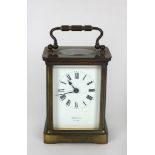 A small brass cased Carriage Clock, the white enamel dial with Roman numerals, and signed Rosenthal,