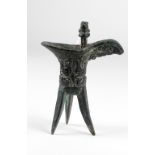 A small heavy Qing Dynasty bronze tripod Ritual Jug, cast with birds, and one handle,