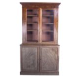 A mid-19th Century mahogany Bookcase, the moulded cornice over two glazed doors,
