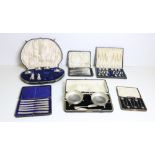 A varied collection of cased silver Presentation Sets, of spoons, butter dishes, knives, teaspoons,