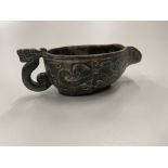 An early Chinese "Archaic" carved Spinach Jade Libation Jug or Cup, with shaped mythical handle,