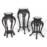 A set of three varied graduating carved Chinese Plant Stands,