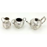 An attractive Victorian silver Bachelors Tea Service, with repoussé decoration comprising a teapot,