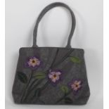 A grey ground Lulu Guinness Handbag, decorated with purple flowers,