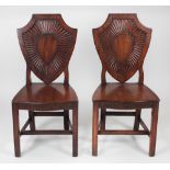 A pair of George III Irish mahogany Hall Chairs,
