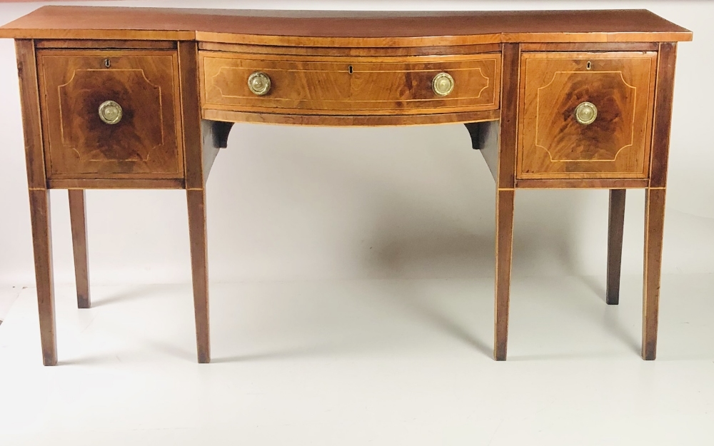 A 19th Century mahogany bow fronted Sideboard, the plain top over an inlaid central drawer,