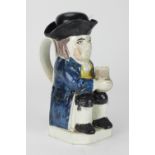 An important 18th Century earthenware Toby Jug, decorated with semi translucent coloured glazes,