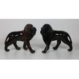 A pair of heavy ebonised carved wooden Models of growling rampant Lions, each approx.