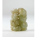 A 19th Century carved celadon jade Figurine, depicting two immortals holding a lotus leaf, approx.